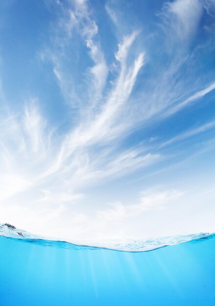 Waterline with sea underwater and blue sunny sky