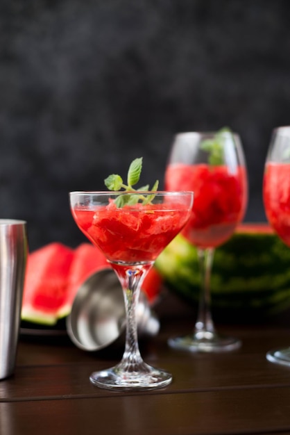 Watermelon alcoholik or non alcoholic cocktail with mint on dark background