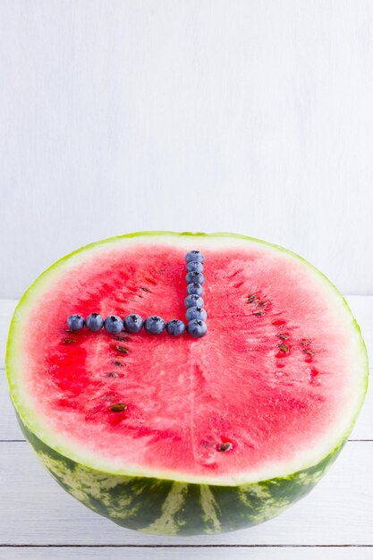 Watermelon and blueberries on white background Half of watermelon on wooden boards Berries for vegan