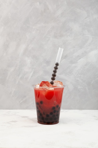 Watermelon bubble tea or fruit boba drink in plastic cup Delicious iced drink with tapioca pearls