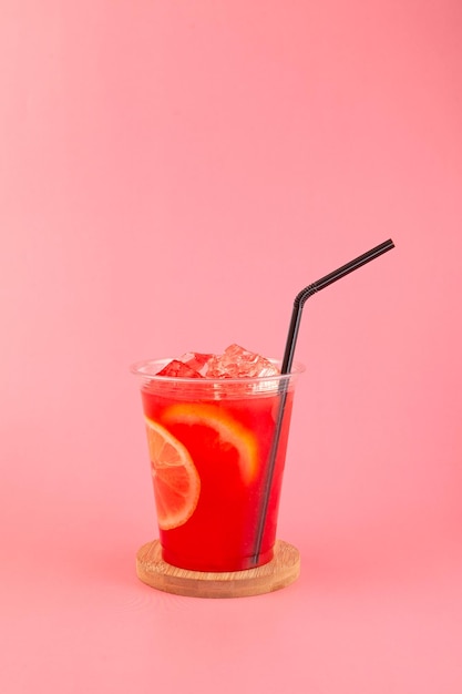 Watermelon citrus sangria in disposable take away plastic cup  Watermelon mojito fresh red drink