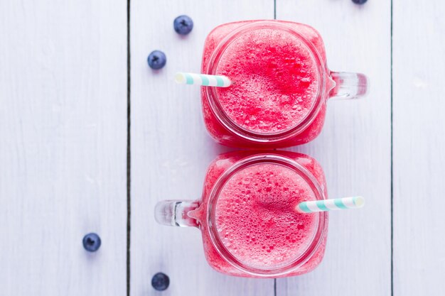 Photo watermelon drink in mason jars with slices of watermelon watermelon smoothies and blueberries