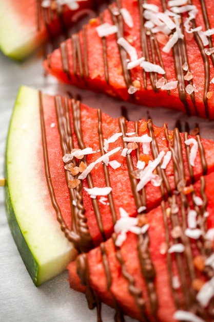 Watermelon drizzled with chocolate and topped with flaked sea salt and coconut.