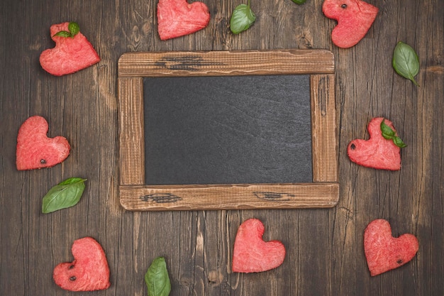 Watermelon hearts on wooden table