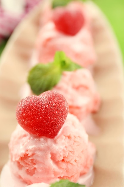 Watermelon ice cream in bowl on color wooden background