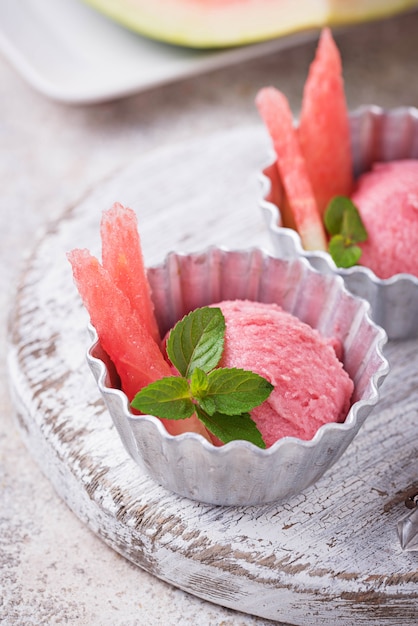 Watermelon ice cream in metal bowls 