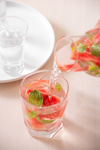 Watermelon infused water on white surface