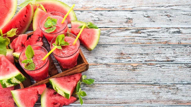 Watermelon juice with mint and ice in a glass Melon On a white wooden background Free space for text Top view