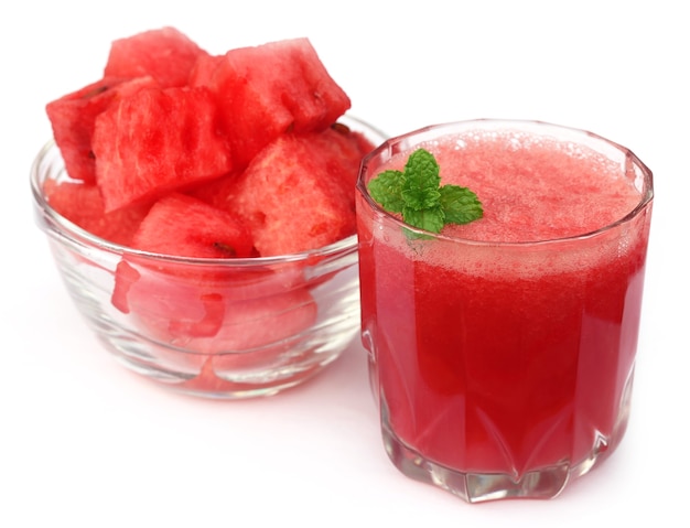 Watermelon juice with mint leaves over white background