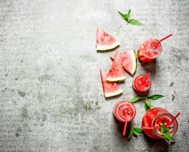 Watermelon juice with mint on stone table.