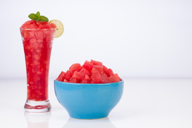 Watermelon Mojito watermelon with lemon and mint arranged in a white transparent glass