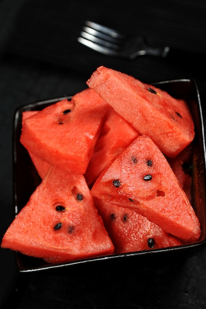 Watermelon pieces in a black bowl