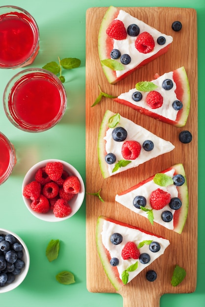 Watermelon pizza slices with yogurt and berries, summer dessert