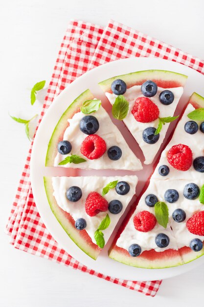 Watermelon pizza slices with yogurt and berries, summer dessert