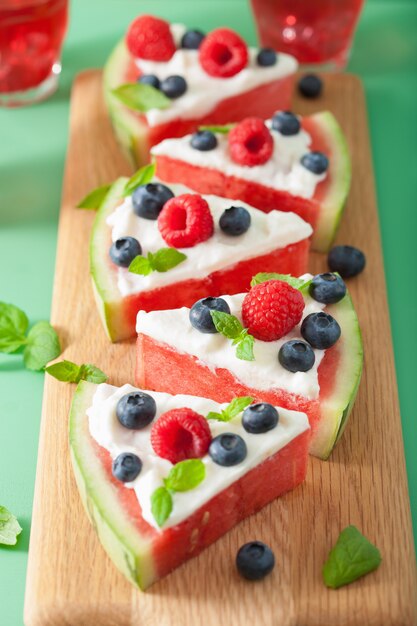 Watermelon pizza slices with yogurt and berries, summer dessert