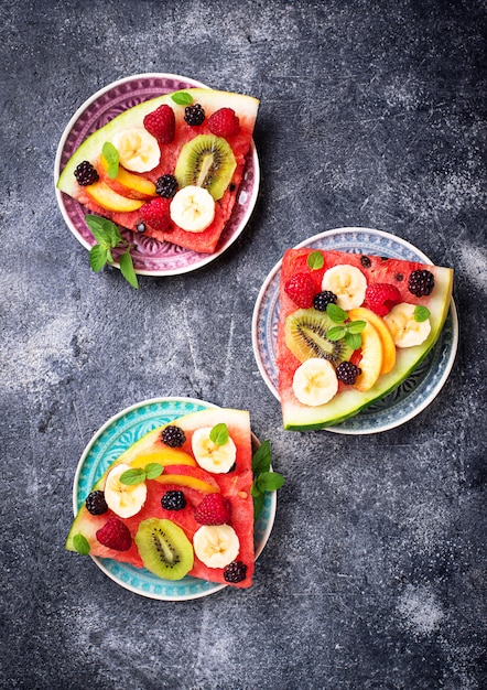 Watermelon pizza with fruit and berries