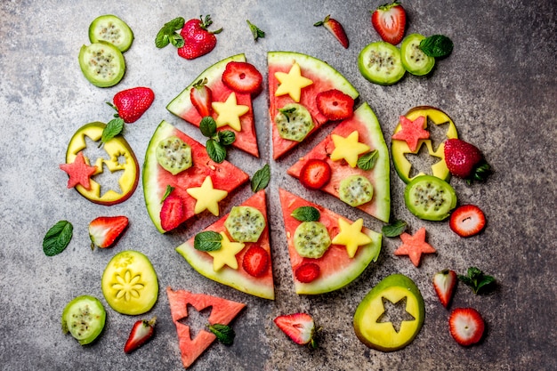 watermelon pizza with tropical fruits and berries