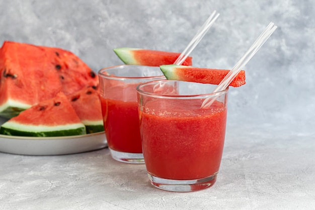 Watermelon pulp smoothie. Delicious red sliced watermelon on a plate. Stock of fiber and fructose. Summer food concept.