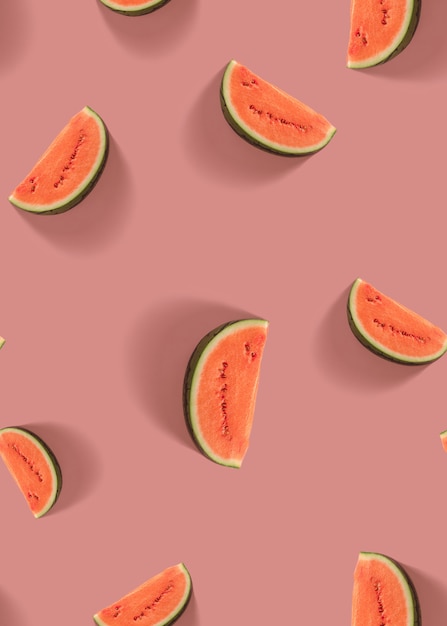 Watermelon slice seamless pattern on pastel pink background