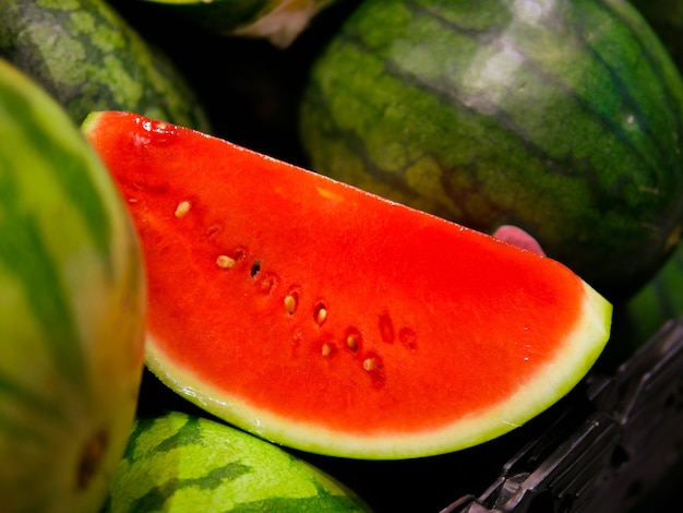 Watermelon slice with watermelon backdrop.