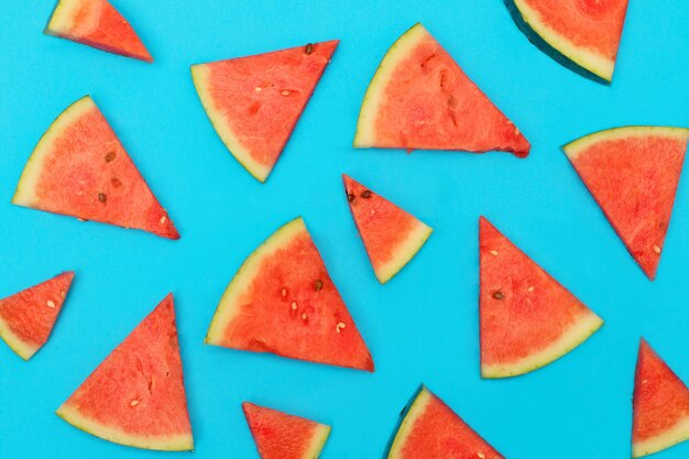 Watermelon slices on blue pastel 