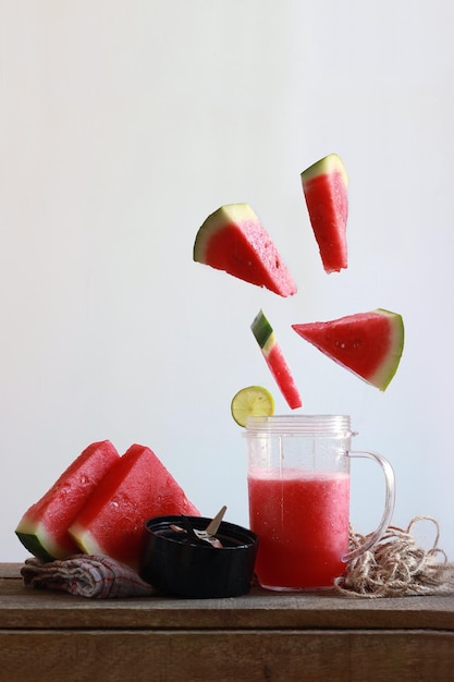 Photo watermelon slices with juice on table against white background