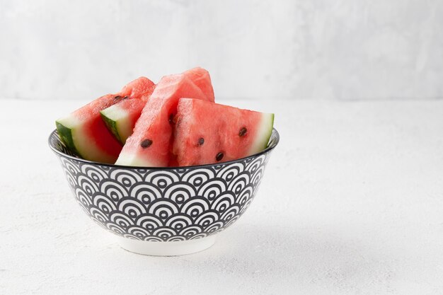 Watermelon slices with seeds on gray background fresh juicy fruit on a plate