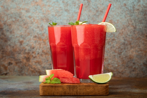 Watermelon slushie summer refreshing drink in tall glasses.