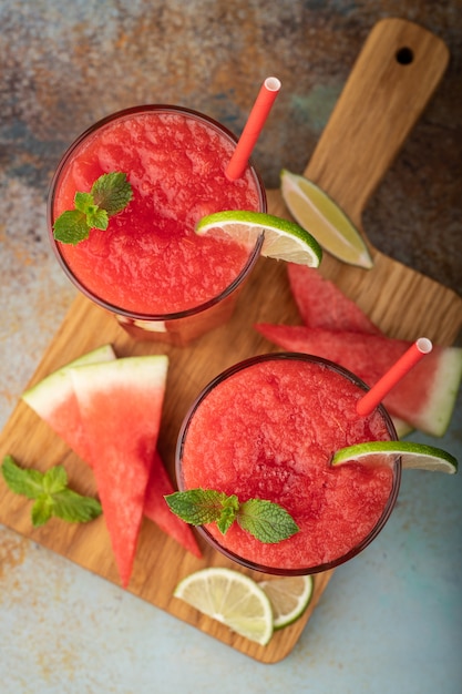 Watermelon slushie summer refreshing drink in tall glasses.