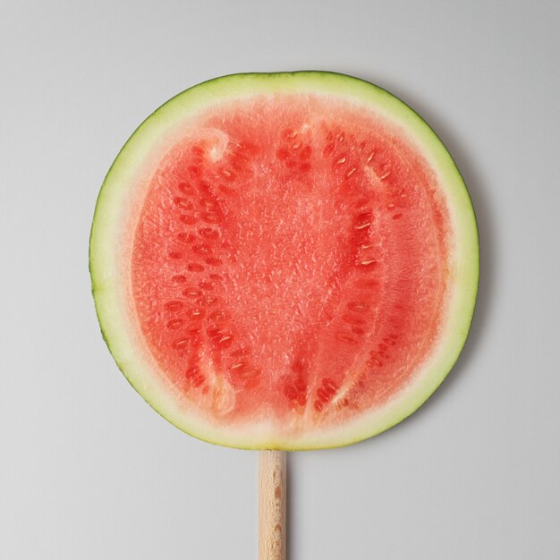 Watermelon on a stick close-up on a gray background.  Top view.