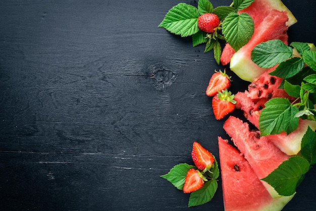 수박 딸기 민트 나무 보드에 과일 슬라이스 상위 뷰 텍스트를 위한 여유 공간