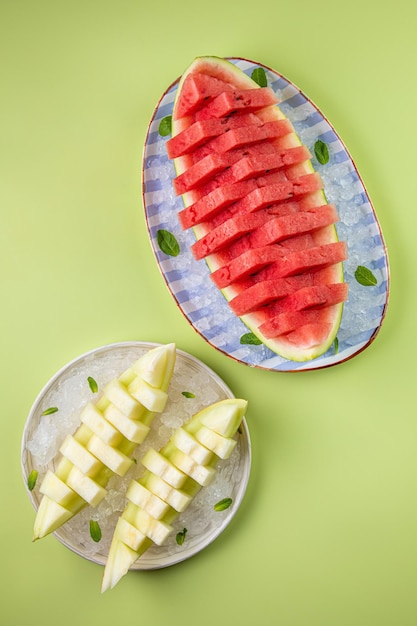 Watermelon and water splash isolated on pastel green background Minimal fruit