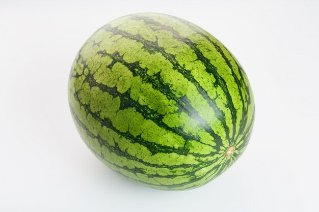 Watermelon with striped peel on white