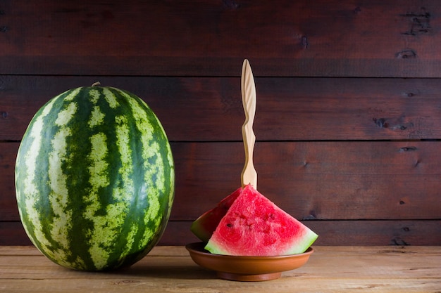 Watermelon on wooden boards Whole watermelon on wooden background Healthy food for vegan Copy space