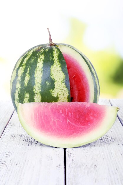 Watermelon on wooden table on natural background