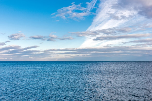 Wateroppervlak van de zee en de wolken in de blauwe lucht
