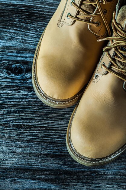 Waterproof protective boots on wooden board