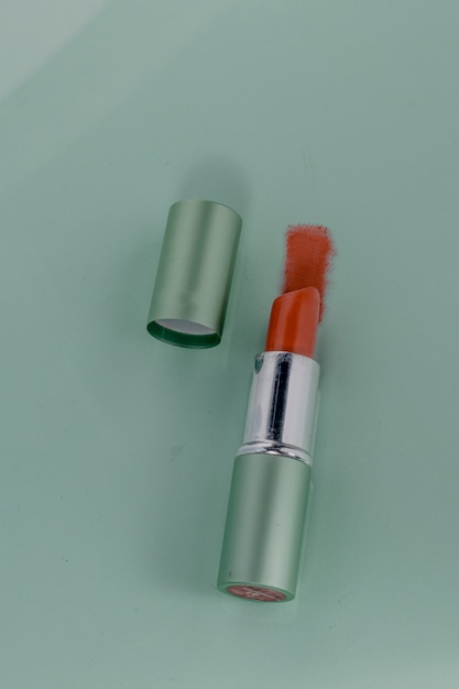 Waterproof red lipstick on a green background