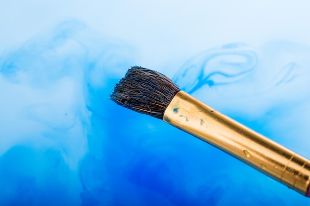 Waterverf verf oplossen in water als schilder penseel raakt water