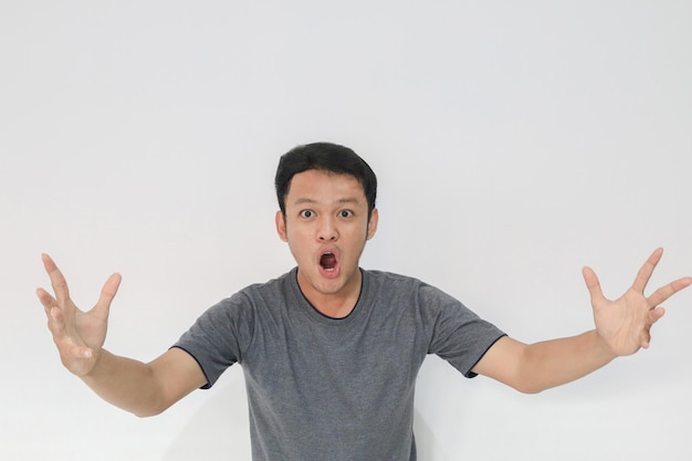 Wauw en geschokt gezicht van jonge Aziatische man met open handgebaar Reclamemodelconcept