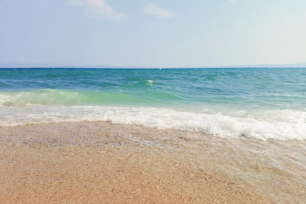 Wave of blue ocean on sandy beach Summer Background