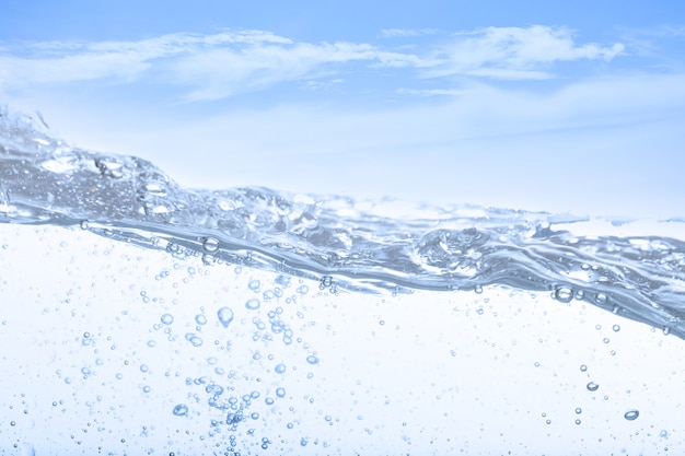 Photo wave of drinking water and bubble air white sky background.
