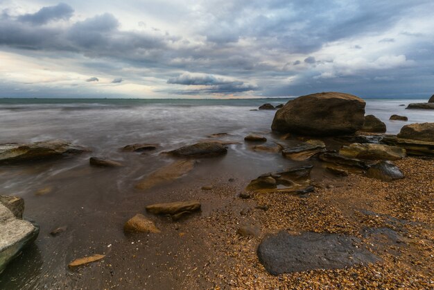 Wave splashing at the rocks freshness on beach