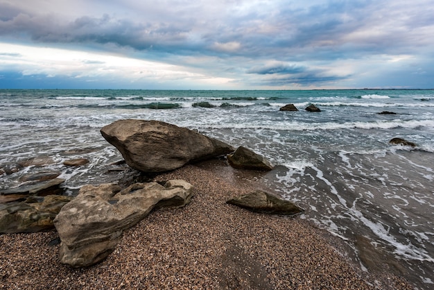 Wave splashing at the rocks freshness on beach