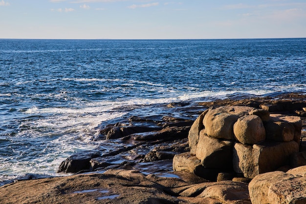 Waves along ocean coast of Maine with boulder formations