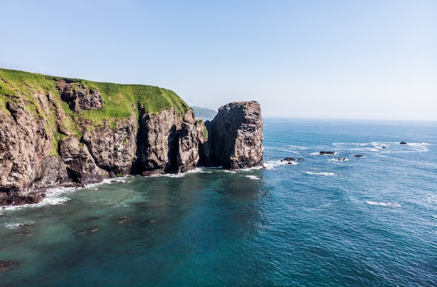 The waves are hitting the cliffs.