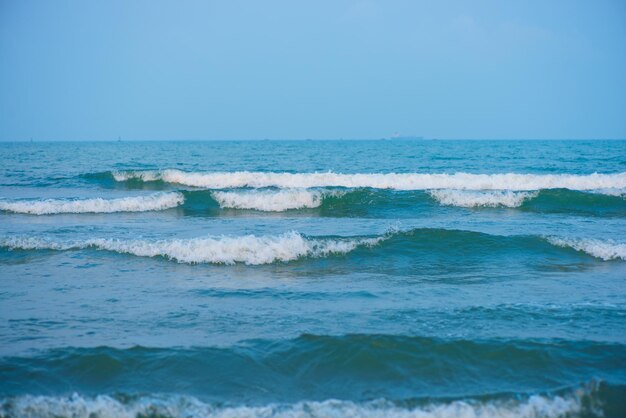 Waves on the beach Blue sea wave Blue water surface texture with ripples splashes and bubbles