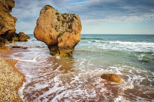 Waves beat against the coastal sea rock rocks beach and\
beautiful turquoise sea water exotic beach beautiful landscape\
composition of nature general\'s beaches crimea