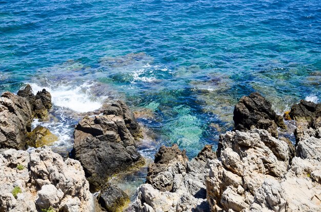 Waves beat against the rocky shore in rethymnon