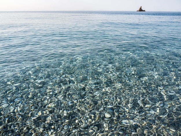 Waves and beautiful sunset on the Greek island Evia Euboea in the Aegean Sea